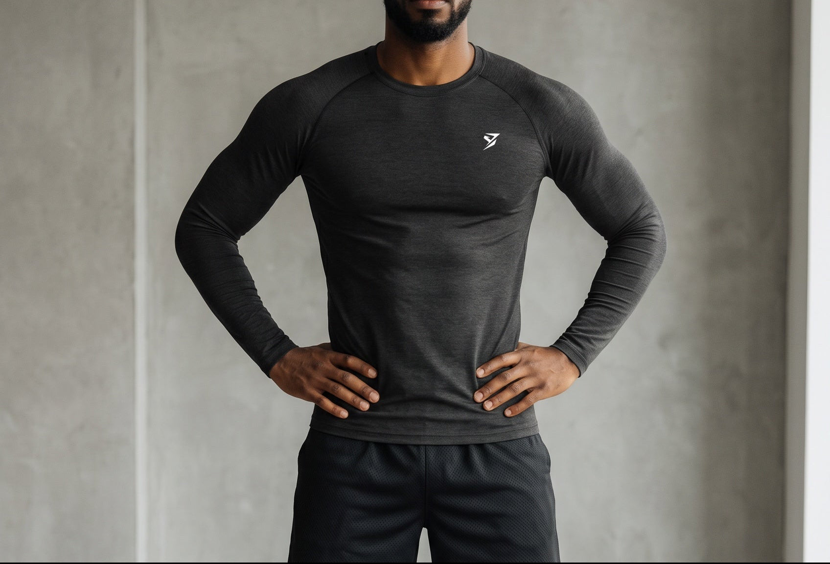 Stryvn black polyester and spandex blend long sleeve t-shirt with a round neck and white logo on the chest.