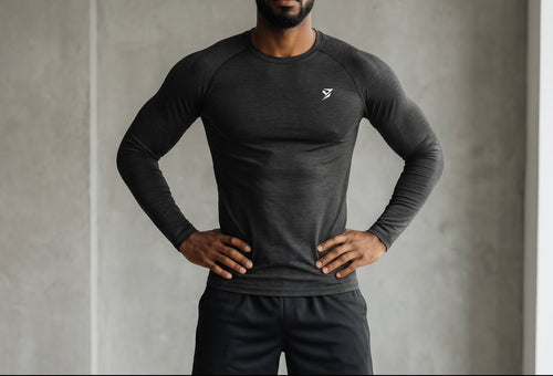 Stryvn black polyester and spandex blend long sleeve t-shirt with a round neck and white logo on the chest.