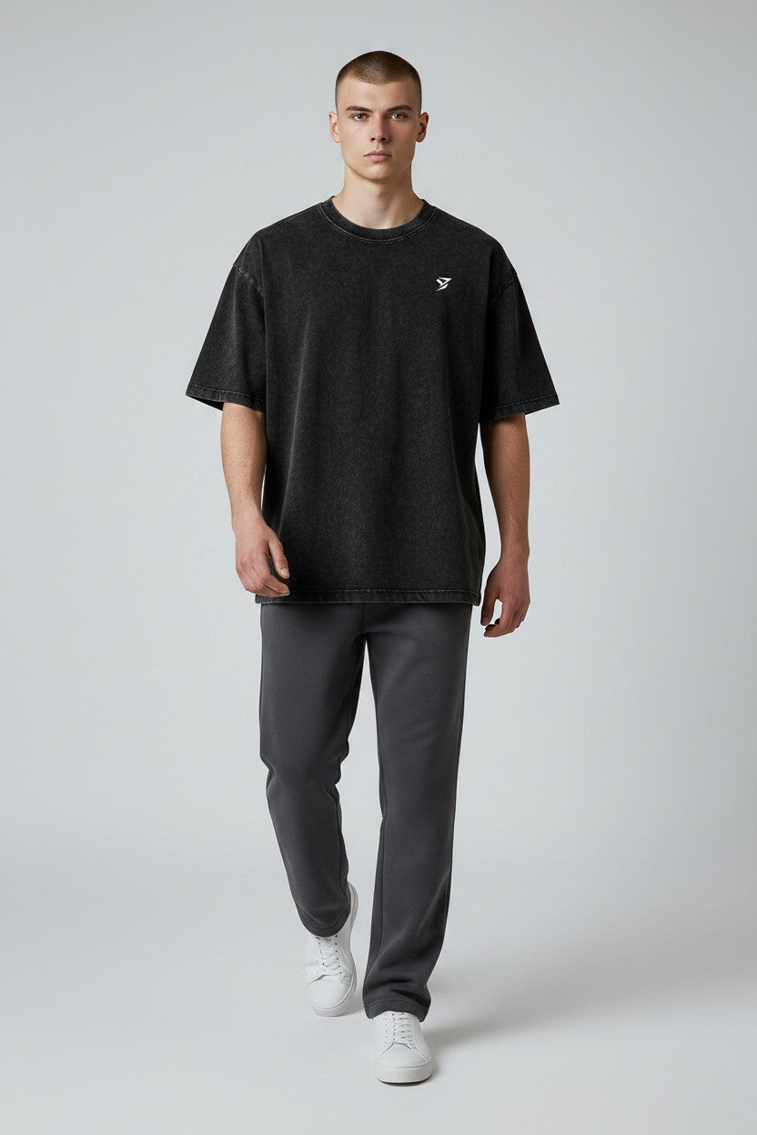 Stryvn black oversized cotton t-shirt with a washed effect and a small white logo on the chest. Relaxed fit for everyday performance.