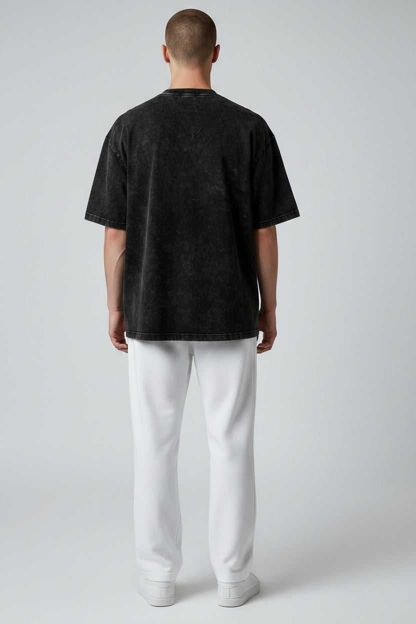 Stryvn black oversized cotton t-shirt with a washed-out effect, relaxed fit for everyday performance and comfort.