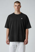 Stryvn black oversized cotton t-shirt with a washed effect and small white logo on chest. Relaxed fit for everyday performance.
