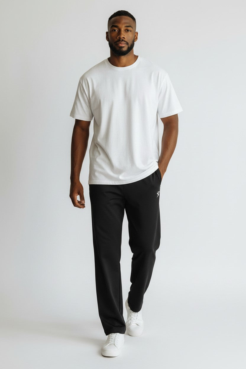 Stryvn black straight-leg sweatpants with elastic waistband and white logo detail on left thigh.