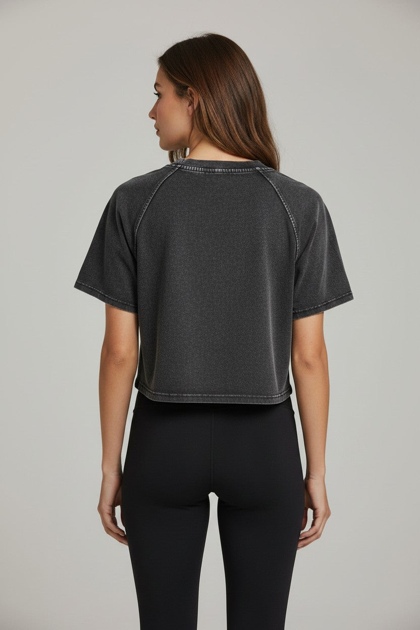 Stryvn women's relaxed fit crop t-shirt in charcoal grey acid wash cotton with short sleeves and raglan seams.