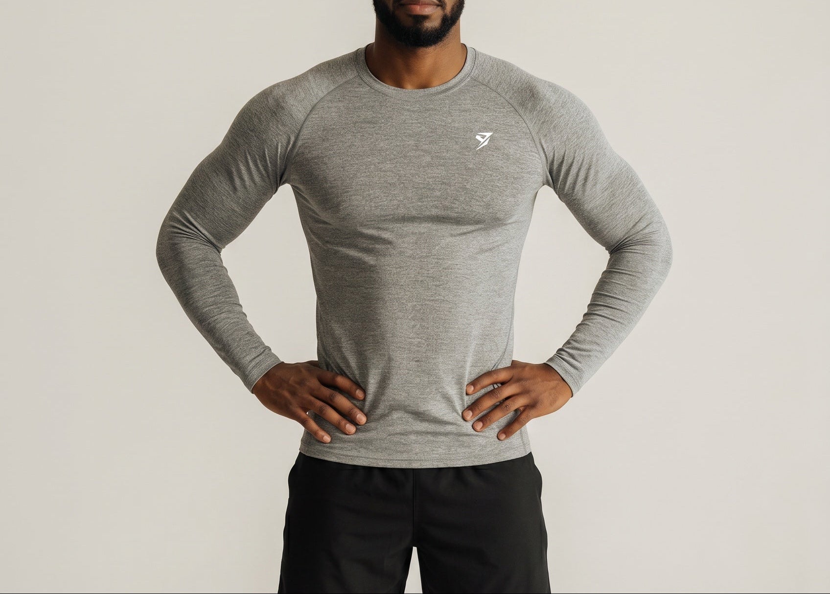 Stryvn grey long sleeve performance t-shirt for men, made from polyester and spandex blend, featuring a round neck and raglan sleeves.