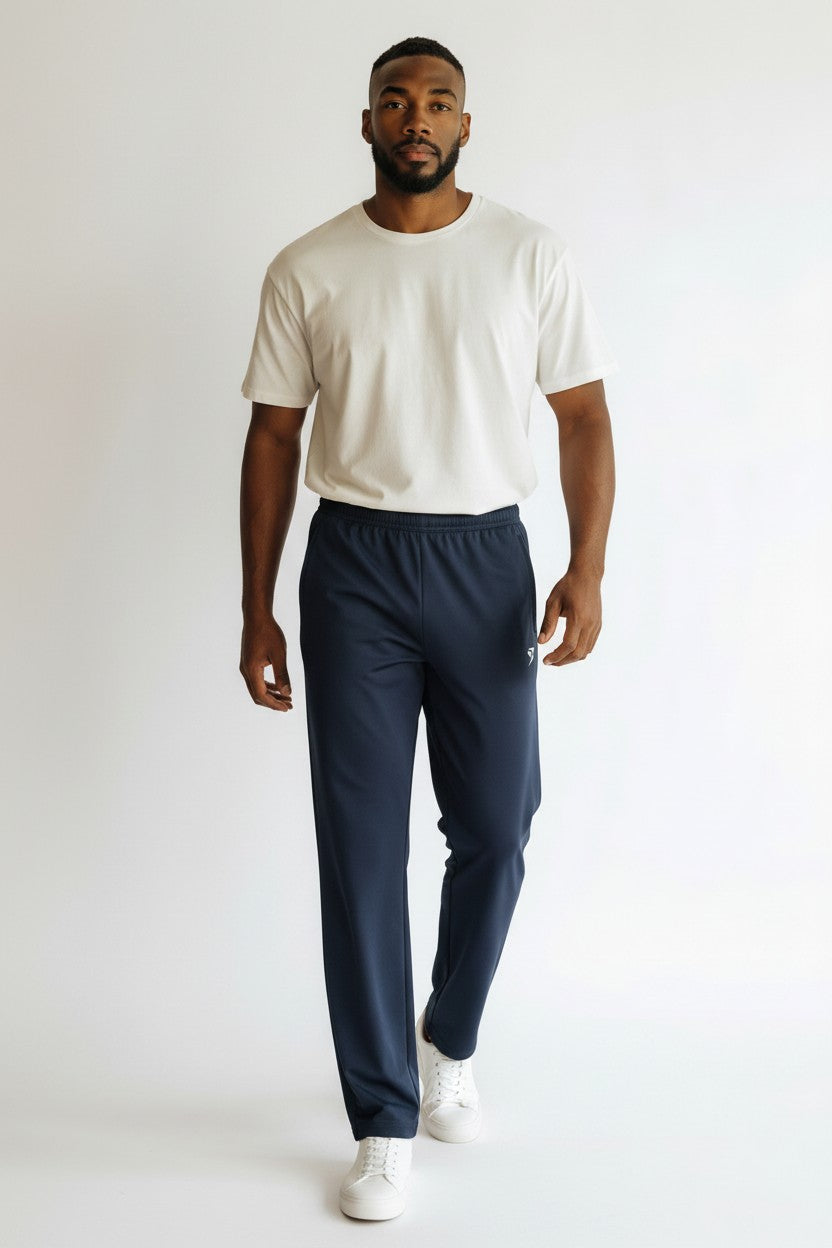 Stryvn navy blue straight-leg sweatpants with elastic waistband and side pockets. Features a small white logo on the left thigh.