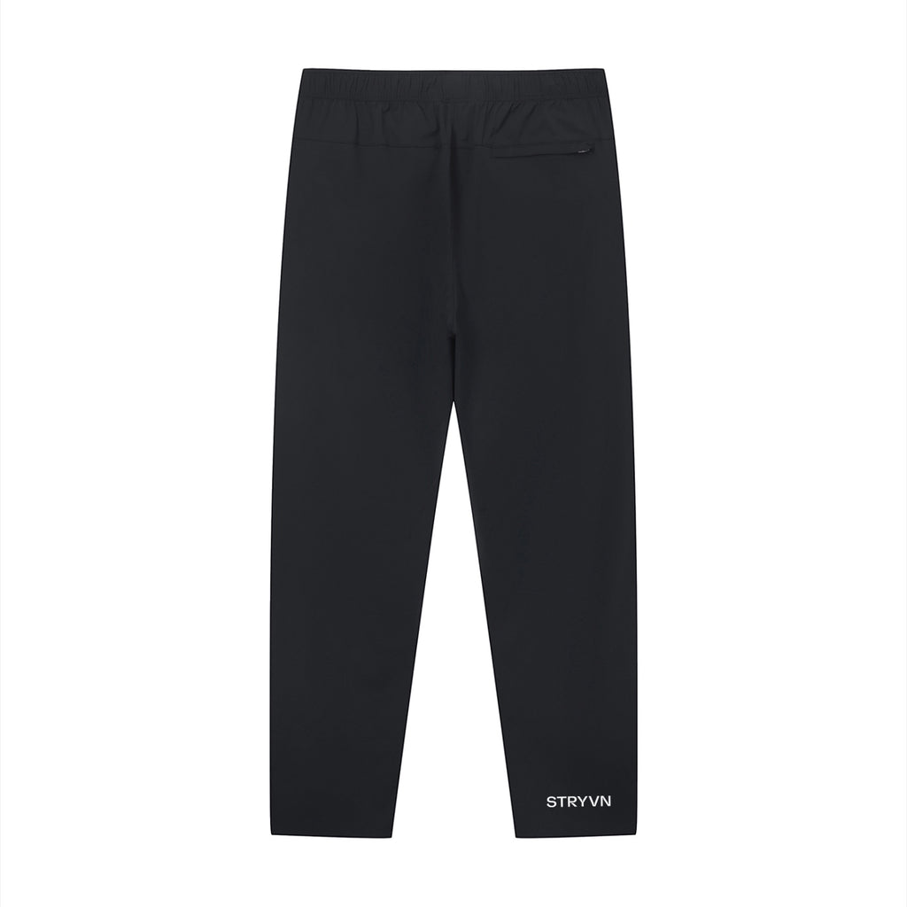Stryvn black performance track pants with athletic fit and lightweight feel. Features a back pocket and subtle logo.