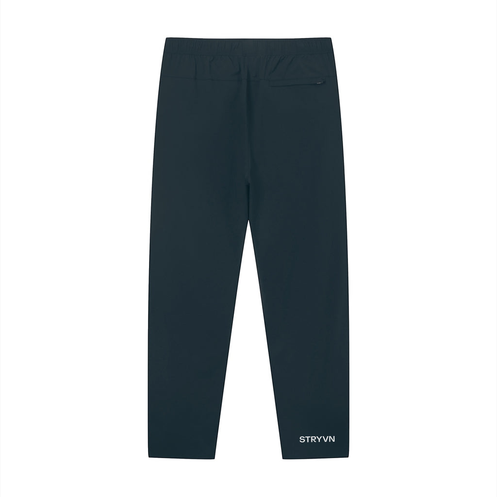 Stryvn unisex performance track pants in dark navy blue, featuring an athletic fit and lightweight feel.